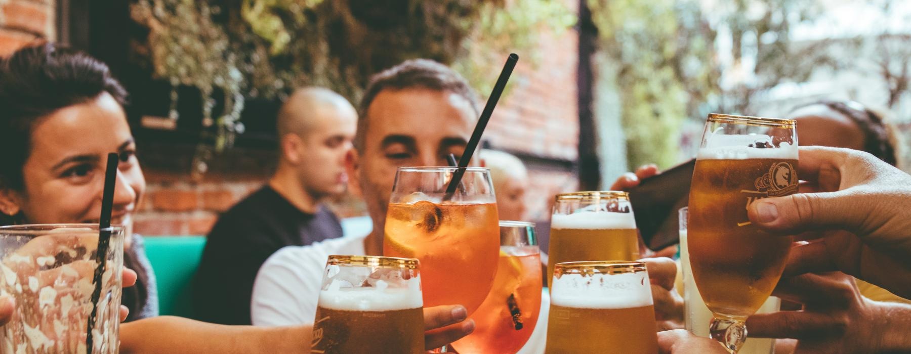 a group of people holding glasses of beer