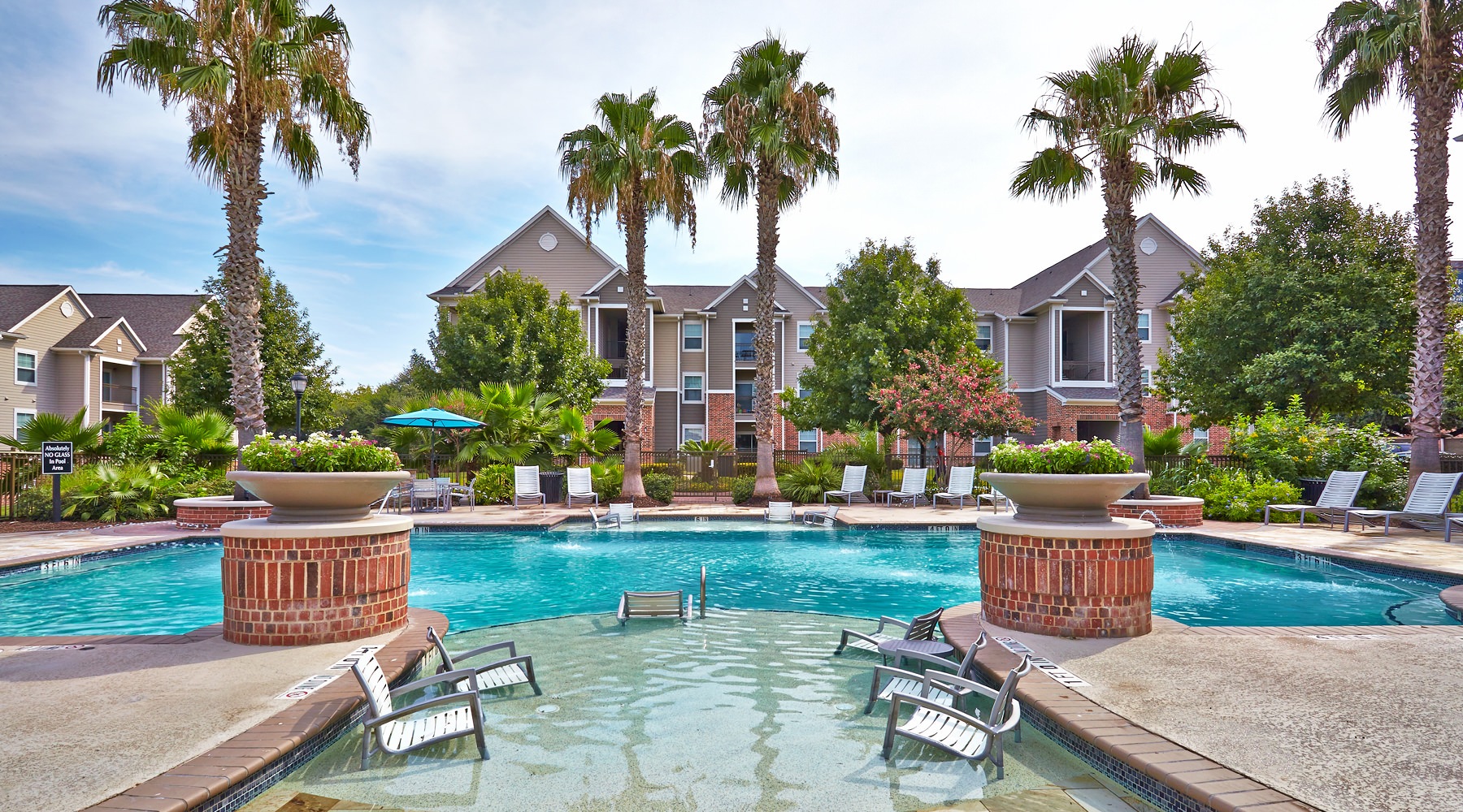 Resort-style swimming pool with lounge seating
